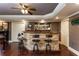 Bar area with stone detailing, dark trim, shelving, recessed lighting, and bar stool seating at 5175 Wilshire Xing, Cumming, GA 30040