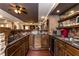 Basement bar with wood cabinetry, granite countertops, tile backsplash and stainless steel appliances at 5175 Wilshire Xing, Cumming, GA 30040