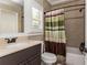 Bathroom featuring a modern vanity and shower with green and brown striped curtain at 5175 Wilshire Xing, Cumming, GA 30040