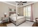 Serene bedroom with four poster bed, soft colors, and natural light at 5175 Wilshire Xing, Cumming, GA 30040