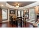 Dining area featuring wood table, chairs, stone wall accents, hardwood floors, and natural light at 5175 Wilshire Xing, Cumming, GA 30040