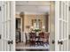 Elegant dining room featuring hardwood floors, wainscoting, a chandelier, and a dining table with seating at 5175 Wilshire Xing, Cumming, GA 30040