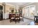 Traditional dining room featuring a round table, classic chandelier, and large windows with plantation shutters at 5175 Wilshire Xing, Cumming, GA 30040