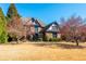 Beautiful two-story brick home with a manicured front lawn and mature trees under a blue sky at 5175 Wilshire Xing, Cumming, GA 30040