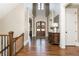 Grand foyer features soaring ceilings, hardwood floors, and an impressive staircase with decorative accents at 5175 Wilshire Xing, Cumming, GA 30040