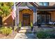 Charming brick home entrance with arched doorway, decorative wreaths, and a cozy porch swing at 5175 Wilshire Xing, Cumming, GA 30040