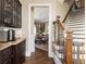 Hallway view to dining room: granite countertops and wood cabinets by staircase at 5175 Wilshire Xing, Cumming, GA 30040