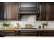 Kitchen featuring dark cabinets, stone countertops, and stainless steel appliances and a gas cooktop at 5175 Wilshire Xing, Cumming, GA 30040