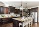 Kitchen featuring dark cabinets, stainless steel appliances, and a large center island with bar stool seating at 5175 Wilshire Xing, Cumming, GA 30040