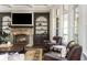 Inviting living area with a fireplace, built-in shelves, and natural light from multiple windows at 5175 Wilshire Xing, Cumming, GA 30040