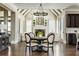 Open concept kitchen and living area featuring a large center table and fireplace at 5175 Wilshire Xing, Cumming, GA 30040