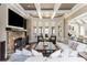 Inviting living room with a stone fireplace, coffered ceilings, and ample seating for entertaining at 5175 Wilshire Xing, Cumming, GA 30040