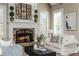 Close up of living room with stone fireplace, elegant furnishings, and decor at 5175 Wilshire Xing, Cumming, GA 30040