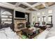 Comfortable living room with a stone fireplace, built-in shelving, and natural light at 5175 Wilshire Xing, Cumming, GA 30040