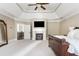 Spacious main bedroom featuring a fireplace and tray ceiling at 5175 Wilshire Xing, Cumming, GA 30040