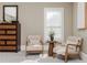 Comfortable sitting area in main bedroom featuring two chairs and a dresser at 5175 Wilshire Xing, Cumming, GA 30040