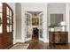 Charming music room with French doors, hardwood floors, piano, guitars, and elegant decor at 5175 Wilshire Xing, Cumming, GA 30040