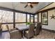 Outdoor patio with ceiling fan, lights, and dining table with mature tree views at 5175 Wilshire Xing, Cumming, GA 30040