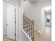Bright hallway with a staircase featuring wood treads and black metal balusters at 1068 Rose Dr, Marietta, GA 30060