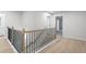 Upstairs hallway showcasing wooden railing and a stairway view at 1068 Rose Dr, Marietta, GA 30060