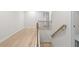 Hallway with wood railing and black spindles overlooking stairs at 1068 Rose Dr, Marietta, GA 30060