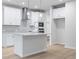 Bright kitchen featuring a center island, stainless steel hood and modern appliances at 1068 Rose Dr, Marietta, GA 30060