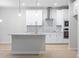 Modern kitchen with stainless steel appliances, kitchen island, and gray backsplash at 1068 Rose Dr, Marietta, GA 30060