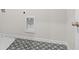 Laundry room featuring patterned flooring, white walls, and utility connections at 1068 Rose Dr, Marietta, GA 30060