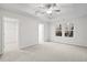 Spacious main bedroom with a tray ceiling, plush carpet, and a walk-in closet at 1068 Rose Dr, Marietta, GA 30060