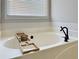 Relaxing bathtub with a modern black faucet, and a caddy tray at 110 Roberts Rd, Suwanee, GA 30024