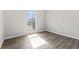 Bedroom featuring hardwood floors and a window with a view of the outdoors at 1295 Brady Ct, Hampton, GA 30228
