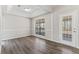Dining room featuring wainscoting, hardwood floors, and large doors and window at 1295 Brady Ct, Hampton, GA 30228