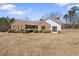 Charming brick home with a well-maintained lawn and mature landscaping in a suburban neighborhood at 1295 Brady Ct, Hampton, GA 30228