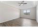 Spacious main bedroom with a tray ceiling, ceiling fan, hardwood floors, and a large window at 1295 Brady Ct, Hampton, GA 30228