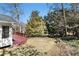 Backyard featuring a wooden deck overlooking a spacious lawn and mature trees at 1501 Sagamore Drive Ne Dr, Atlanta, GA 30345