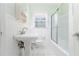 Clean, classic bathroom featuring a pedestal sink and tub shower with sliding glass door at 1501 Sagamore Drive Ne Dr, Atlanta, GA 30345