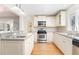 Bright kitchen with white cabinets, stainless steel appliances, and hardwood floors, and a kitchen island at 1501 Sagamore Drive Ne Dr, Atlanta, GA 30345