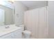 Bathroom with a mirror, white cabinet sink, toilet, and white shower curtain at 675 Ashley Laine Walk, Lawrenceville, GA 30043