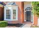 The arched front door is flanked by a bay window at 675 Ashley Laine Walk, Lawrenceville, GA 30043