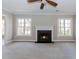 Bright living room features a fireplace, large windows, neutral paint, and plush carpeting at 675 Ashley Laine Walk, Lawrenceville, GA 30043