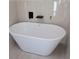 Elegant white soaking tub with modern fixtures and a tiled surround at 2615 Fox Hall Ln, Atlanta, GA 30349