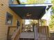 Outdoor wooden deck area with an open covering and ceiling fans at 2615 Fox Hall Ln, Atlanta, GA 30349