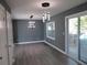 Dining room featuring modern lighting, sliding glass doors to the deck, and wood floors at 2615 Fox Hall Ln, Atlanta, GA 30349