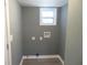 Empty laundry room ready for appliances, featuring a window and hookups at 2615 Fox Hall Ln, Atlanta, GA 30349