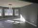 Sun-filled living room featuring wood floors, and three windows at 2615 Fox Hall Ln, Atlanta, GA 30349