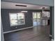 Open living area with wood floors, modern lighting, sliding doors to the deck, and grey walls at 2615 Fox Hall Ln, Atlanta, GA 30349