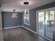 Modern living room with gray walls, wood floors, sliding door to deck, and contemporary lighting at 2615 Fox Hall Ln, Atlanta, GA 30349