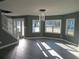 Bright living room with gray walls, wood floors, and ample natural light from large windows at 2615 Fox Hall Ln, Atlanta, GA 30349