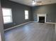 Living room featuring wood floors, a fireplace, and two windows at 2615 Fox Hall Ln, Atlanta, GA 30349