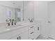 Bathroom featuring double sinks with white cabinets, black hardware, and a large mirror at 488 Hammons Way, Atlanta, GA 30315